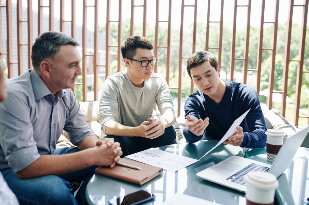 Manager showing report to colleagues