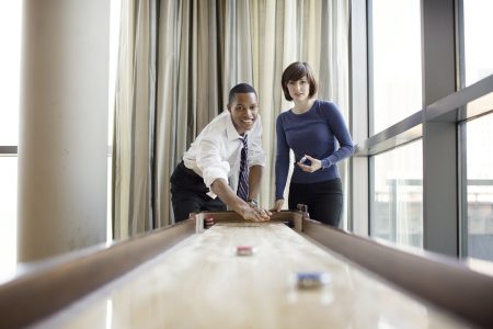 colleagues-playing-shuffleboard-in-office.jpg